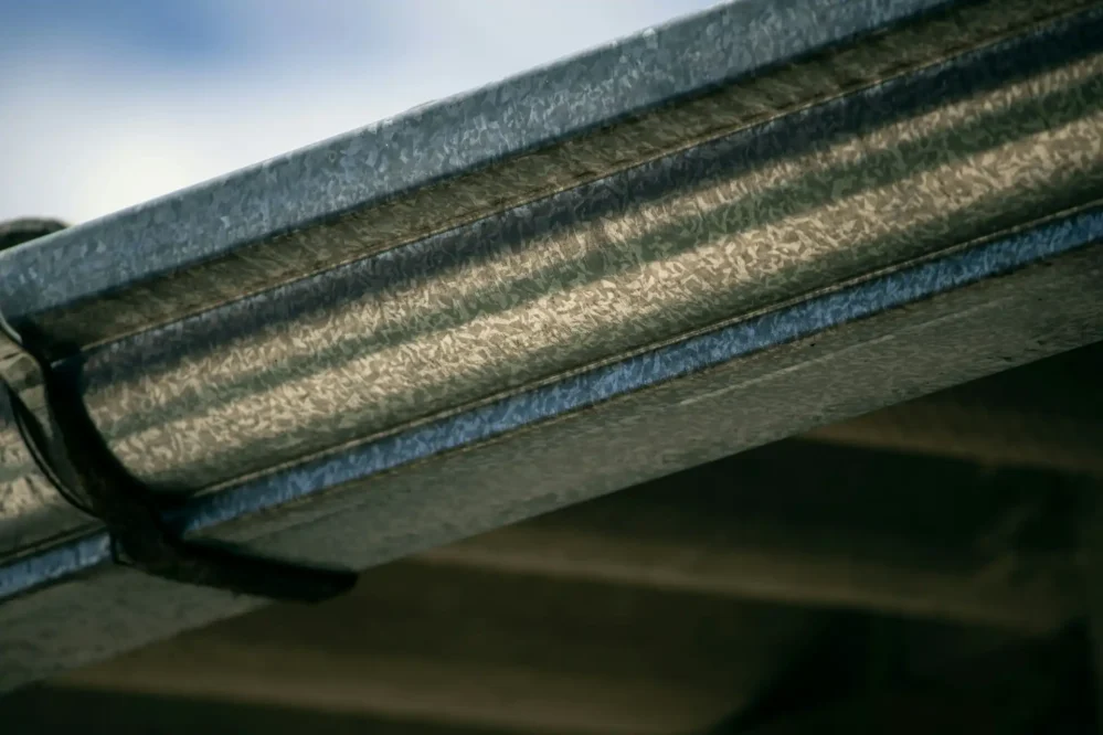 An up close picture of metal gutters on a roof
