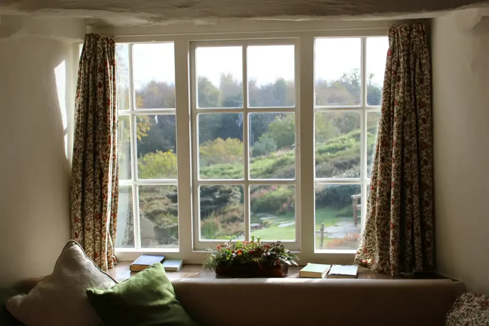 A set of windows with curtains in a home.