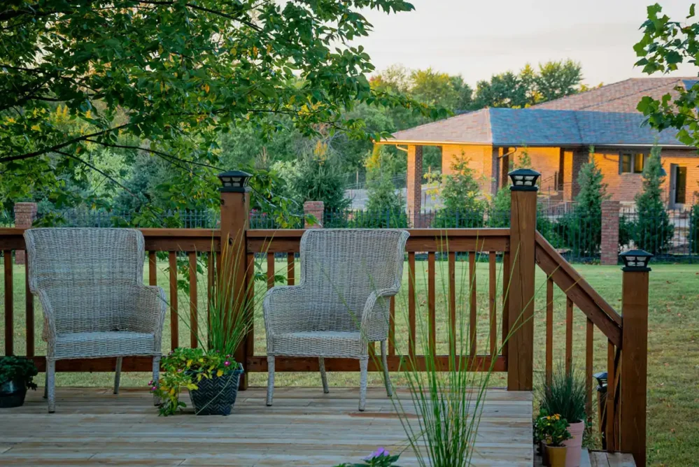 Two patio chairs on a beautiful wooden deck.